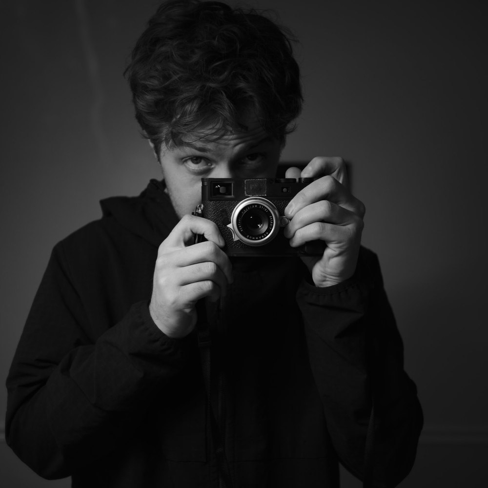 Gabriel Whitney holding a rangefinder camera